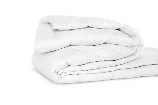 istock Folded soft white blanket, bedspread or duvet for a comfortable sleep. White blanket folded on a white background. Fabric structure. 3D blanket model. Comfortable sleep. Close up photo 1219431351