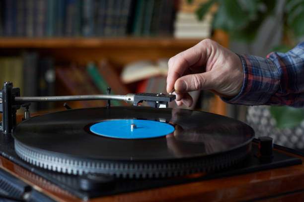 istock Male hand placing the needle on a record plate, selective focus 1219432334
