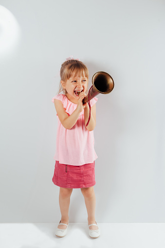 Little girl playing bugle