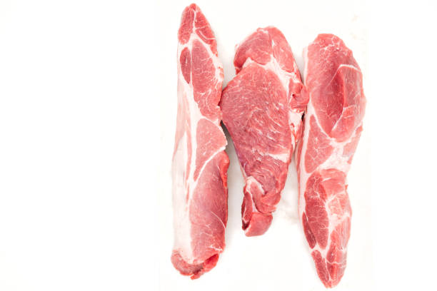 Slices of fresh raw pork meat close up on white background