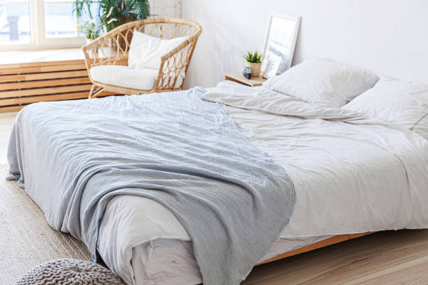 istock Stylish loft bedroom interior. Spacious design apartment with light walls large windows big bed. Clean modern decoration with elegant furniture in minimalist Scandinavian style 1219432864