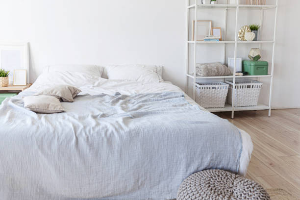 istock Stylish loft bedroom interior. Spacious design apartment with light walls large windows big bed. Clean modern decoration with elegant furniture in minimalist Scandinavian style 1219432885