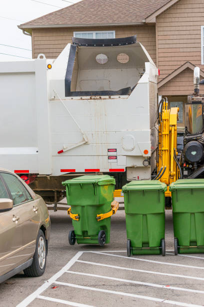 istock Garbage Truck Grabs Trash Can For Dumping