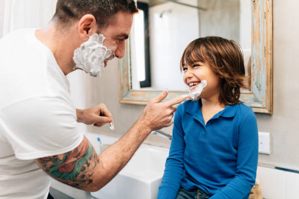 father and son shaving together - tattoo father family son imagens e fotografias de stock