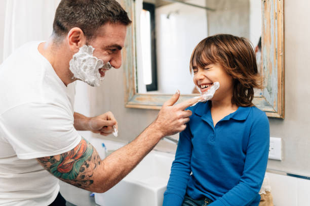 father and son shaving together - tattoo father family son imagens e fotografias de stock