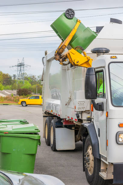 istock Robotic Arm Dumps Trash Into Garbage Truck 1219433954