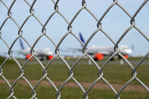 Multiple grounded airplanes parked on the runway. Worldwide the airline industry has been taking a hard financially hit due to the Covid - 19, Corona Virus Pandemic.