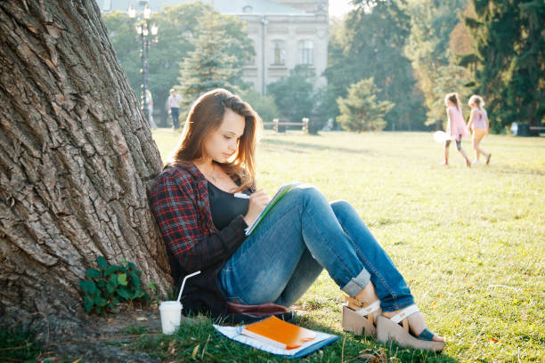 istock girl student near the tree 1219435405