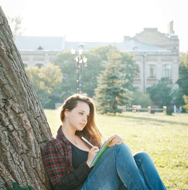 istock girl student near the tree 1219435445