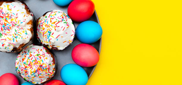 istock Colored painted eggs on a yellow background. Easter banner. Festive banner with place for text. Religious holiday. 1219436468