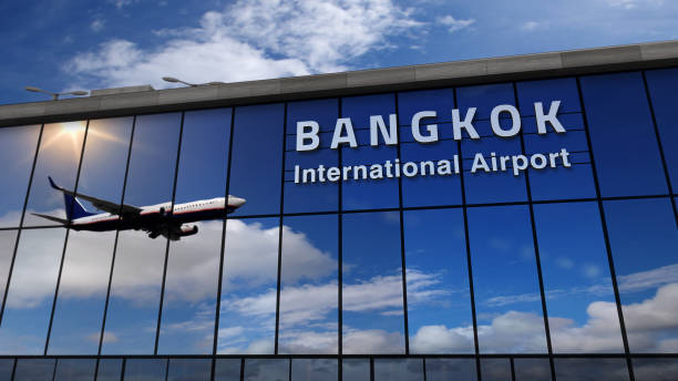 istock Airplane landing at Bangkok mirrored in terminal 1219439499