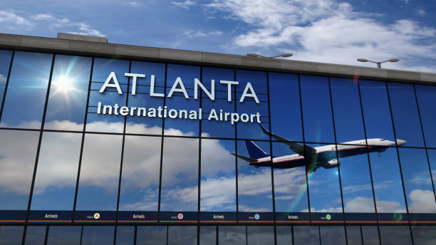 istock Airplane landing at Atlanta mirrored in terminal 1219439565