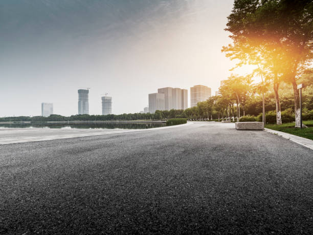 istock empty parking lot with cityscape 1219440858