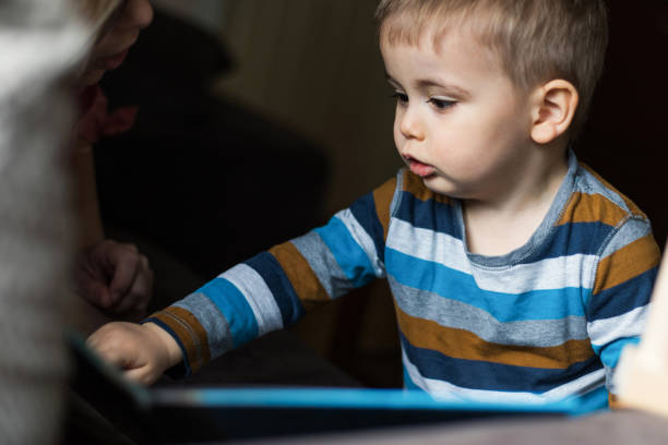istock Smart toddler boy enjoys playing with books 1219442092