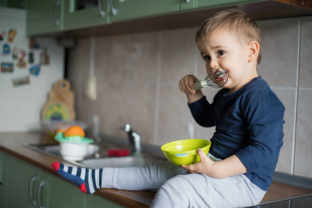 istock Child eating cream from the mixer 1219442171