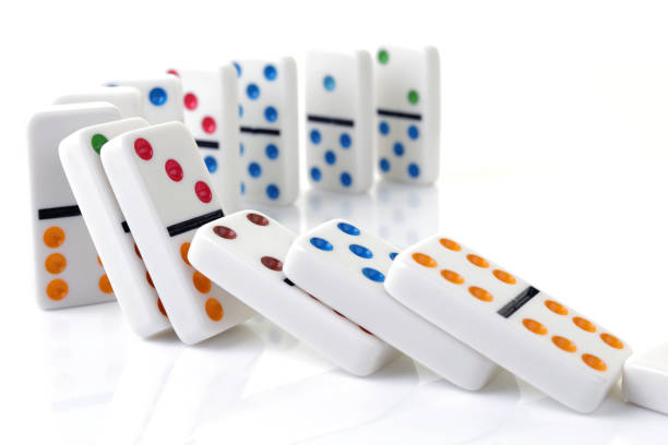 istock Falling colorful dominoes on a white surface 1219442322