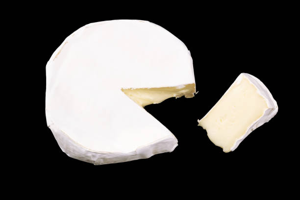 istock Camembert with slices isolated on black background. Soft cheese covered with edible white mold view from above. top view 1219443004