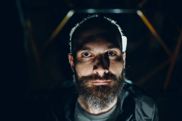 istock Backlit bearded adult man portrait 1219443804