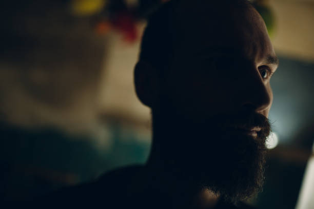 istock Backlit bearded adult man profile portrait 1219443816