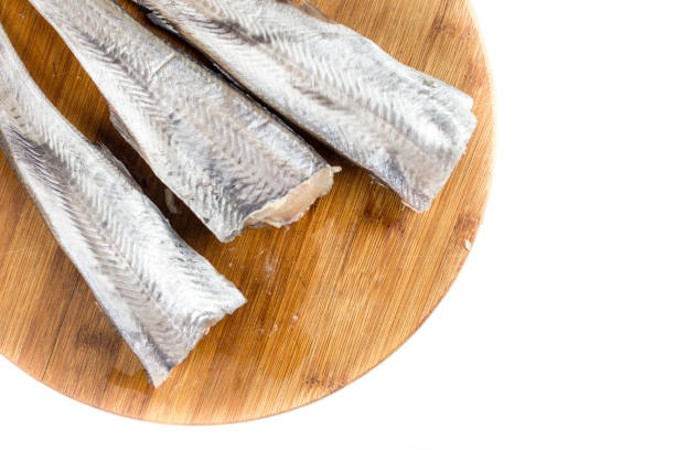 istock Flat lay above fresh raw hake fish on the wooden board with copy space 1219445639