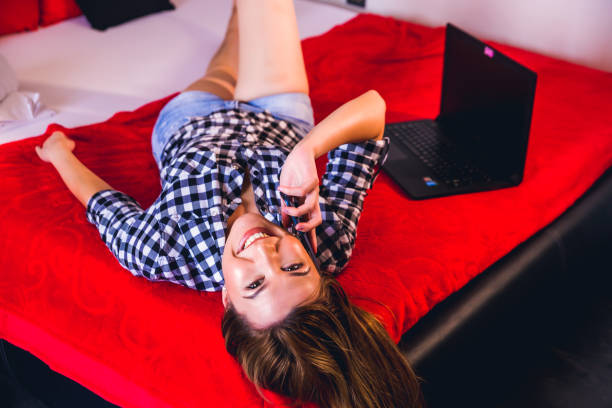 istock Woman talking on the phone in bed 1219447161