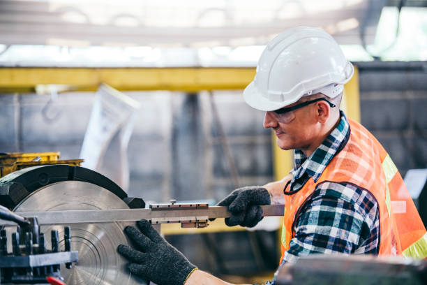 istock Male engineer metalworker industrial experienced operator technician worker in safety hard helmet working on lathe machine, professional man in industry technology manufacturing factory workshop 1219450035
