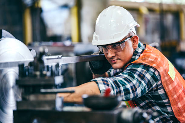 istock Male engineer metalworker industrial experienced operator technician worker in safety hard helmet working on lathe machine, professional man in industry technology manufacturing factory workshop 1219450045