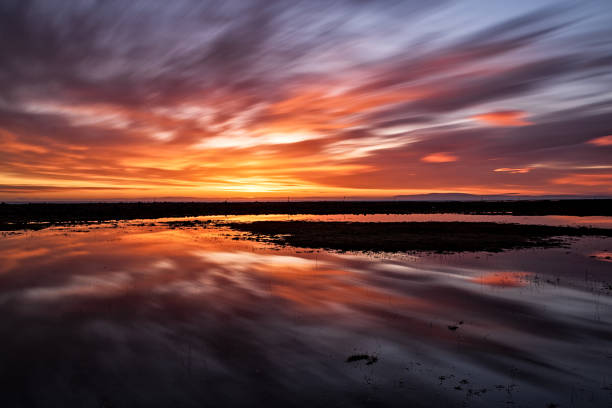 istock Colorful sunset reflected in the water 1219450803
