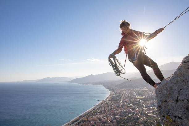 istock Young woman recalls from rock climb summit 1219452529