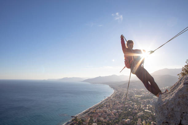 istock Young woman recalls from rock climb summit 1219452895