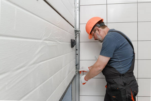 Lifting gates of the garage. The worker is installing the lifting gates of the garage. door repairman men manual worker stock pictures, royalty-free photos & images