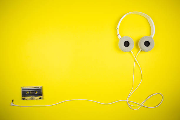 istock Audio cassette tape and modern headphones 1219454268