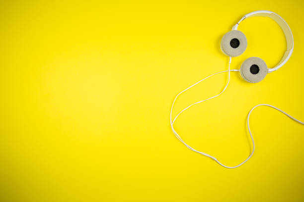 istock White audio headphones with a 3.5 mm wire on a yellow background 1219454399