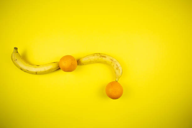 istock Fruit banana and orange on a yellow background 1219455470