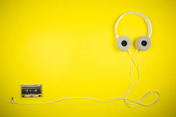 istock Audio cassette tape and modern headphones 1219455488