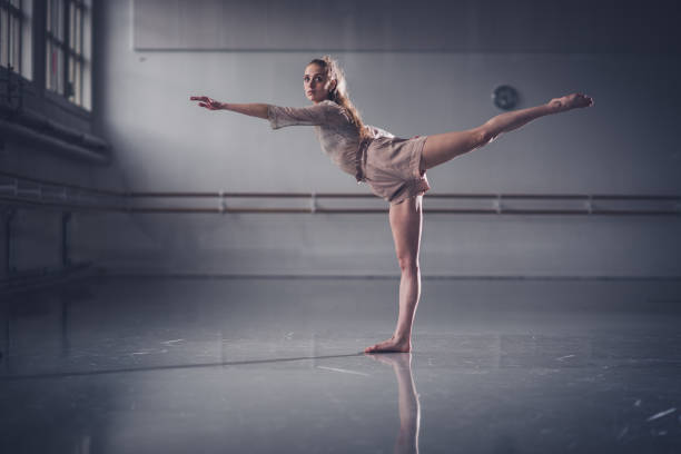 istock Beautiful jazz ballerina having training in studio. 1219455522