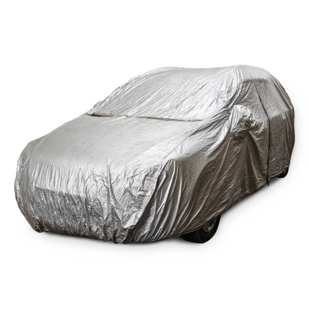 istock Parked car with protective gray rain cover on a white backgraund 1219455738