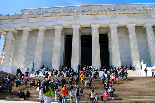 Washington DC, USA - March 28, 2019: Crowds of people on the stairs of the Lincoln Memorial at the National Mall, Washington DC, USA.