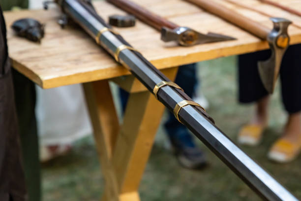 istock weapons iron black barrel, long closeup with gold stripes on a blurred background battle ax 1219456465