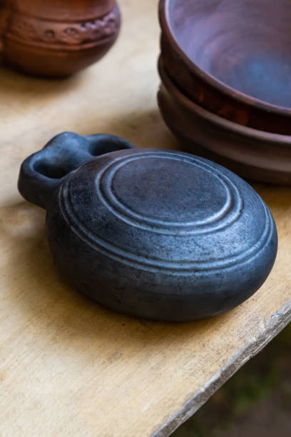 istock flat clay black flask, traditional vessel for storing wine and water 1219456476