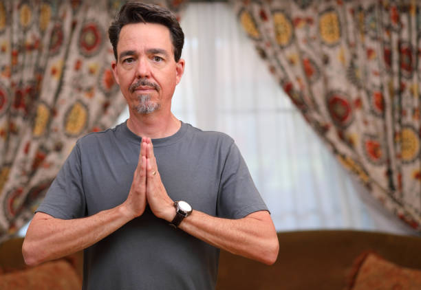 istock COVID-19 Home Exercise Man Does Yoga Heart Center Eyes Open MS Left 1219456762