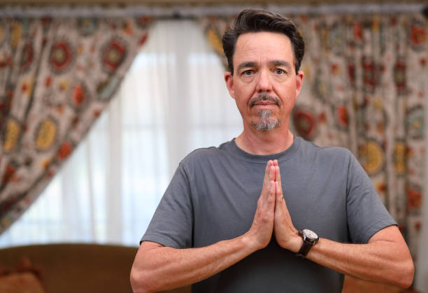 istock COVID-19 Home Exercise Man Does Yoga Heart Center Eyes Open MS Right 1219456782