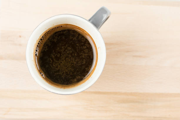 istock Flat lay selective focus above cup of coffee on the blurred wooden board with blank copy space 1219457292