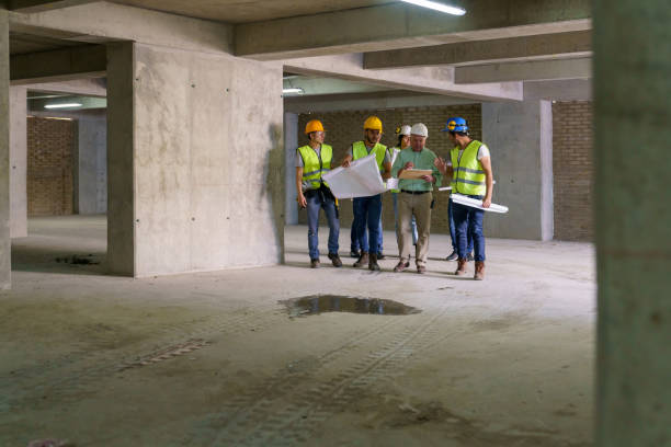 istock Mixed age range of professionals inspecting a building under construction 1219457512