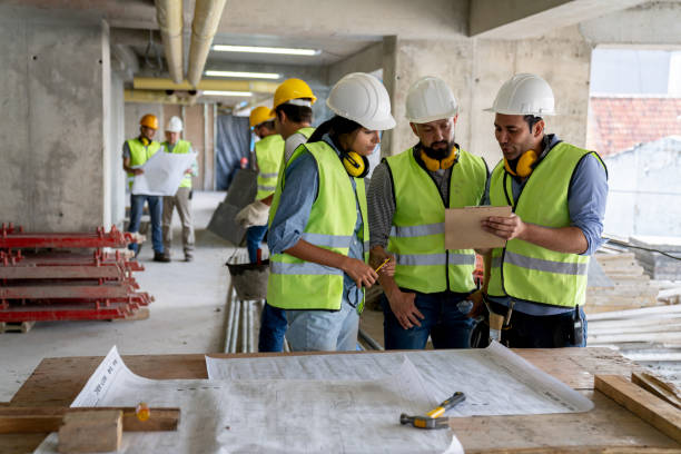 istock Manager showing something to engineer and female architect on clipboard at a construction site project 1219457531