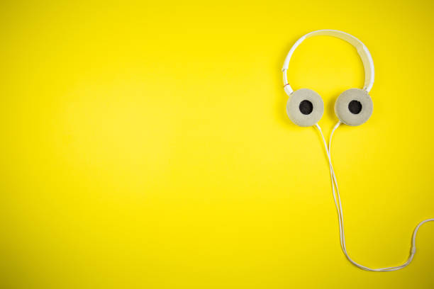istock White audio headphones with a 3.5 mm wire on a yellow background 1219457596