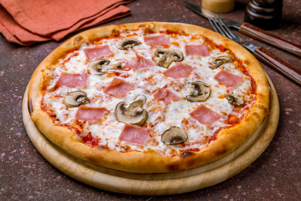 istock Pizza with ham and mushrooms on concrete table 1219458554