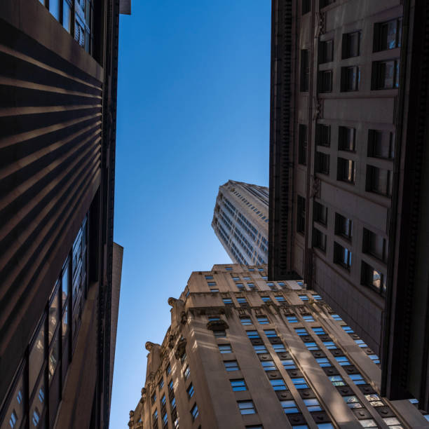 istock Corporate building against the blue sky. Low angle looking up photo. 1219459116