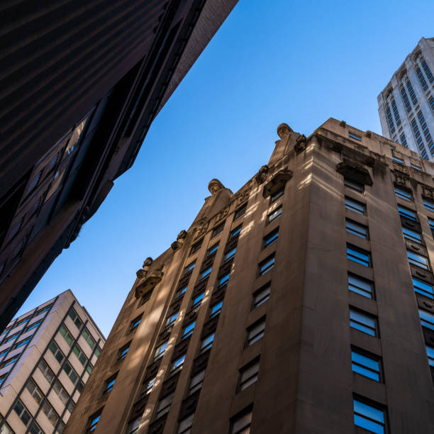istock Corporate building against the blue sky. Low angle looking up photo. 1219459117