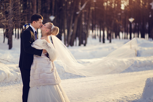Lovers bride and groom in winter day outdoors with copy space.